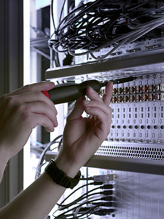 Man repairing connections on a server rack