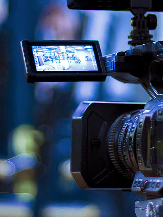 Close up of camera with display unfolded in front of blurred background