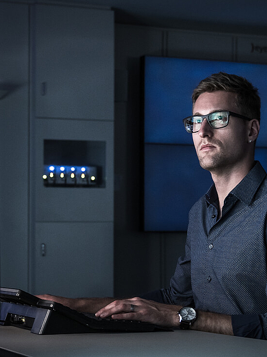 Man in darkened room, face illuminated by screen