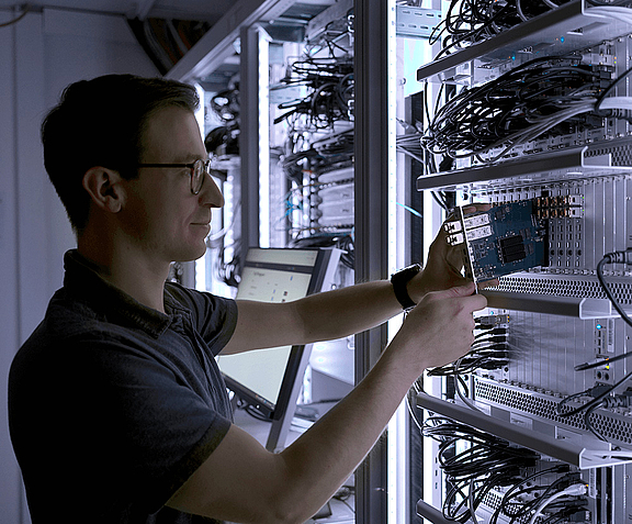 Man repairing connections on a server rack