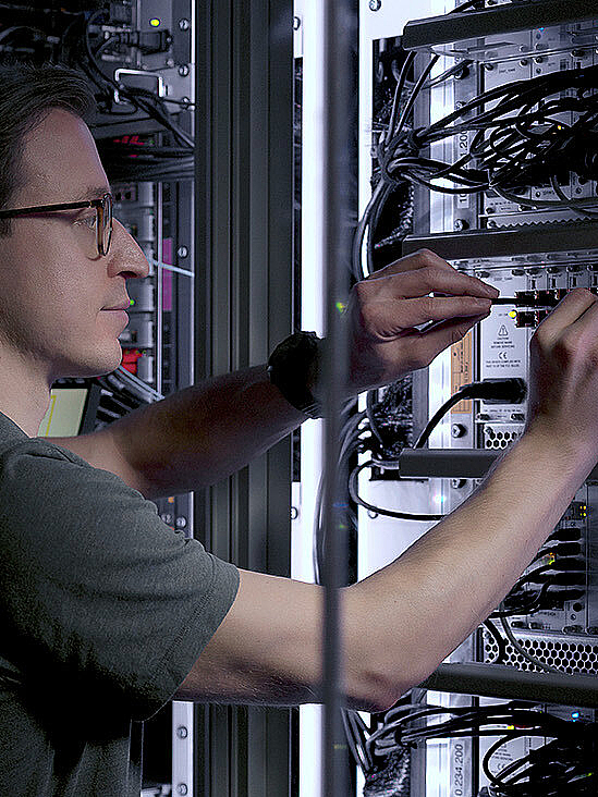 Man making connections in a server room