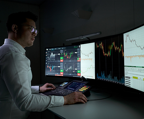  Man in trading business in front of several screens