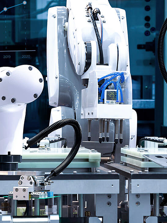 White robot arms in industrial manufacturing