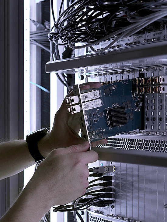  Man in server room installing PC racks